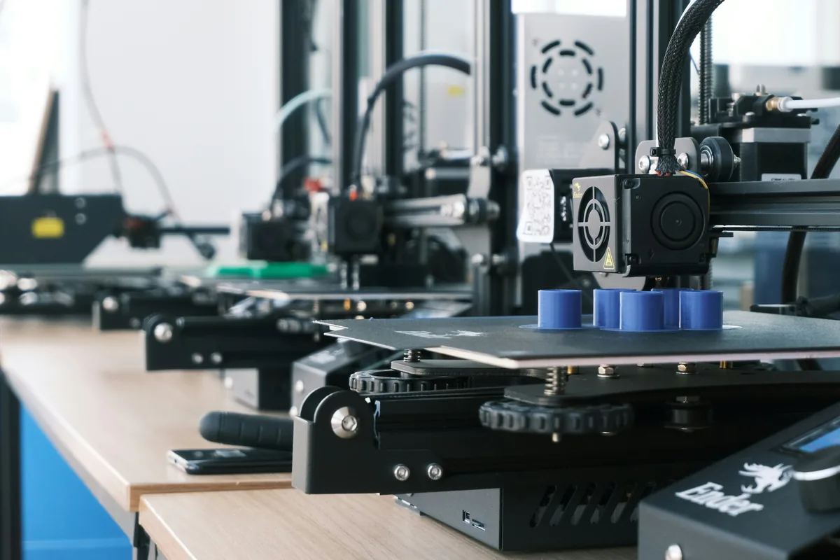 Rows of 3D printers running production jobs on the shop floor